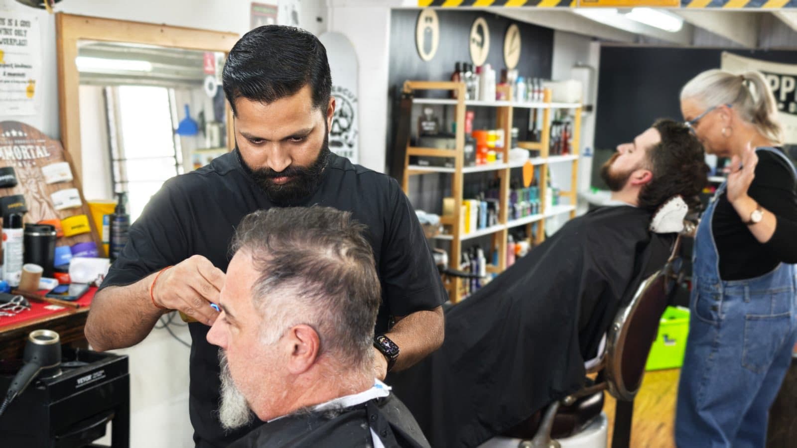 Chandan at work giving a haircut at High St Barber, Echuca
